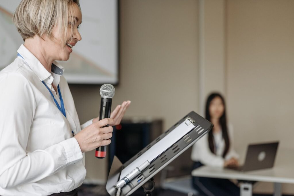 Woman presenting at a business seminar with a microphone