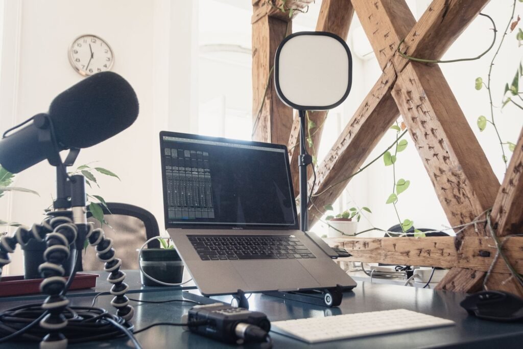Home podcast setup with microphone, laptop and lighting